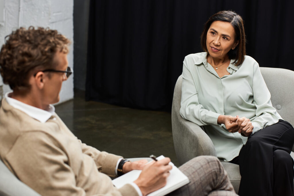PTSD Counseling - woman discussing her mental health with a trauma-informed therapist