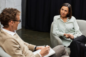 PTSD Counseling - woman discussing her mental health with a trauma-informed therapist